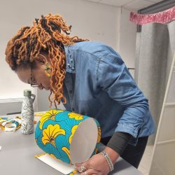 Owner Kala demonstrating how to make a lampshade