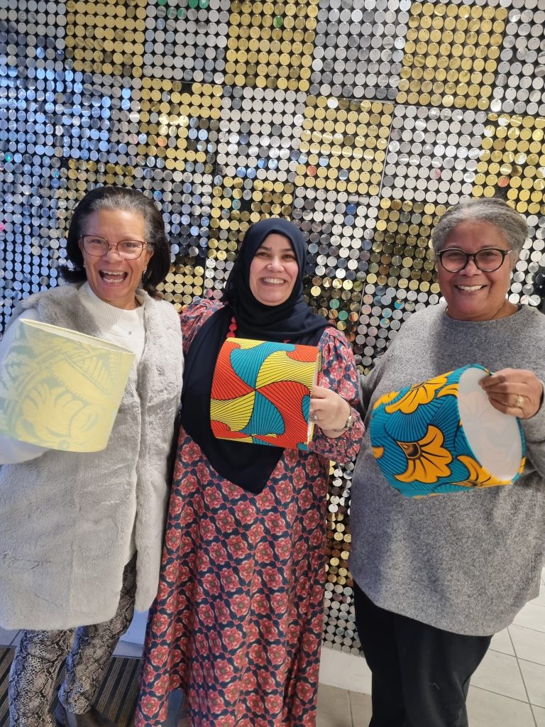 Three ladies showing their handmade lampshades