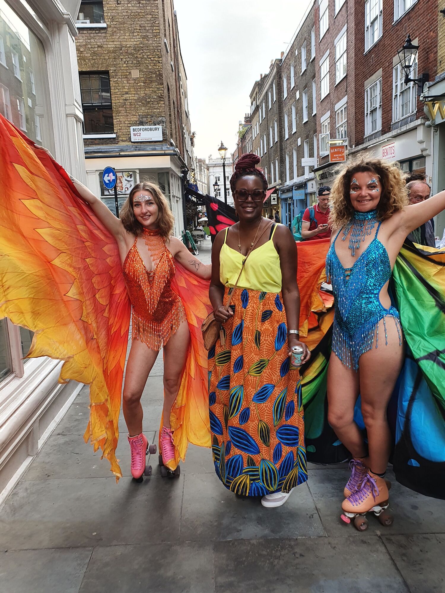 lady in bright by kala x surrounded by carnival dancers