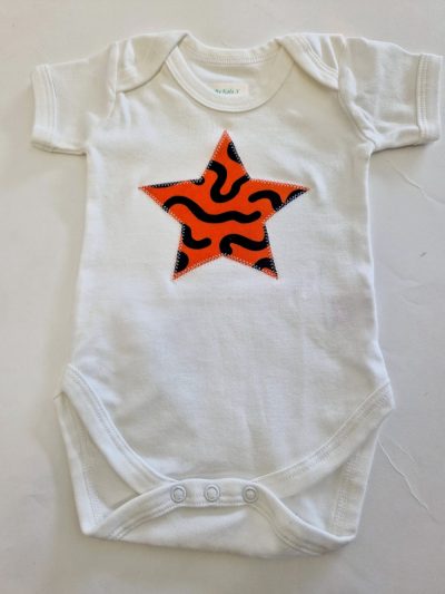 white bodysuit with orange star applique