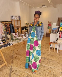 business owner Kala smiles as she stands in Host of Leyton