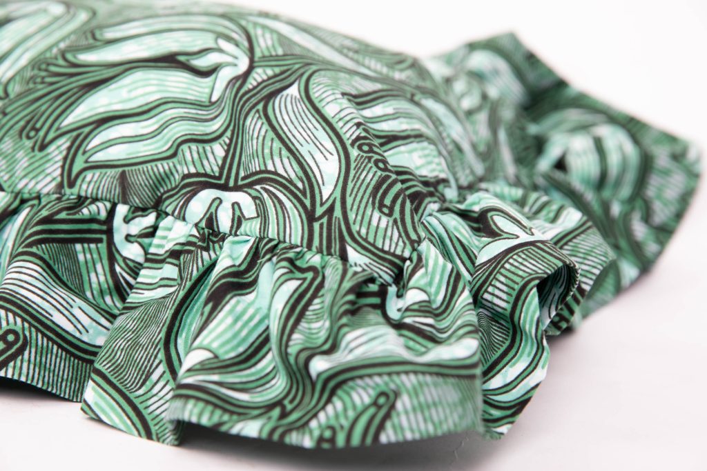 corner of green ruffle statement cushion